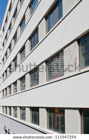 Large uniform parrallel windows of a modern industrial unit.