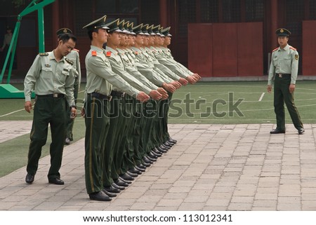 BEIJING - MAY 16: A row of People\'s Liberation Army soldiers stand for inspection, May 16, 2009 in Beijing. It is the world\'s largest military force, with approximately 3 million members.