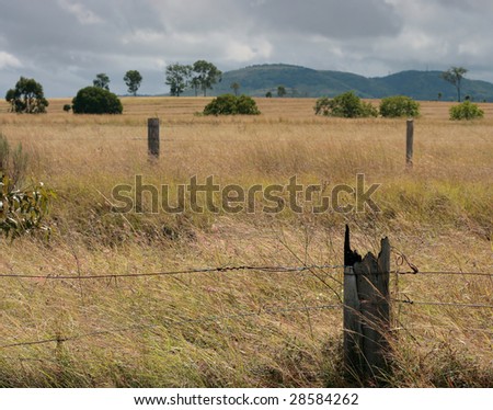 Drought affects the rural areas of Queensland Australia as the sky promises rain.