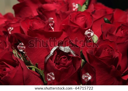 stock photo Bridal bouquet of red roses with platinum wedding rings