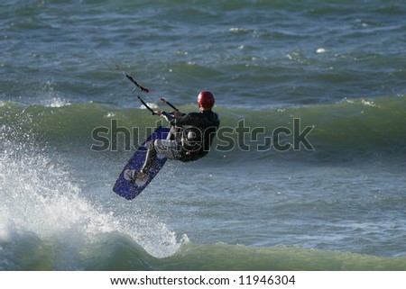 A kitesurfer riding the waves in the ocean