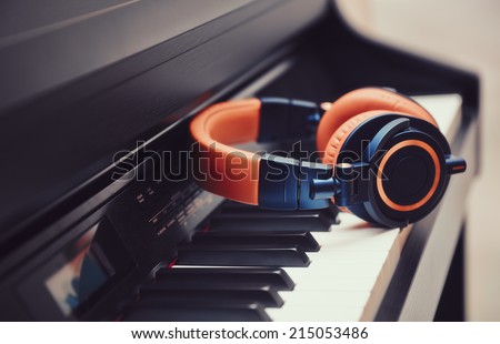 Blue-orange headphones on a digital piano keyboard