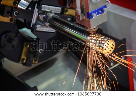 The CNC fiber laser cutting machine cutting the stainless tube,pipe for make holes.