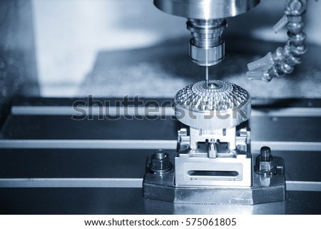 The Hi-precision  CNC milling machine with cutting sample in blue-silver tone.The micro cutting technique in precision part.