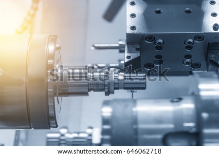 The CNC lathe machine (Turning machine) while drilling the metal rod with the drill and center drill tool .The hi-technology machining concept.