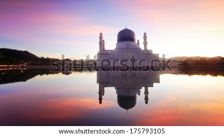 mirror reflection of the majestic mosque in kota kinabalu sabah during awesome sunrise. noise visible due to long exposure