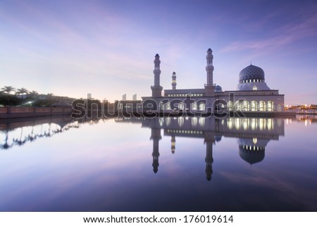 mirror reflection of the majestic mosque in kota kinabalu sabah during dark blue hour