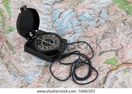 Compass on the map of italian Alps