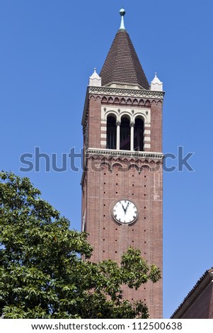 USC clock tower rises above trees on the Los Angeles campus