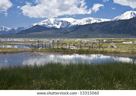 Shallow pools along the north shore of Mono Lake reflect the snow-capped Sierra range in California