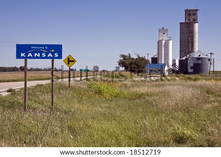 Grain elevators in the tiny town of Saunders stand as greetings at the state line in western Kansas