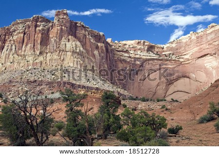 Rugged bluffs rise above a rocky wash in Capitol Reef National Park