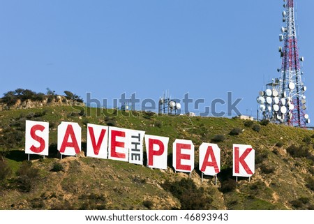 LOS ANGELES – FEB 17: Activists cover the famous Hollywood sign with the message “Save The Peak” to protest the development of homes on the land.  February 17, 2010 in Los Angeles, California.