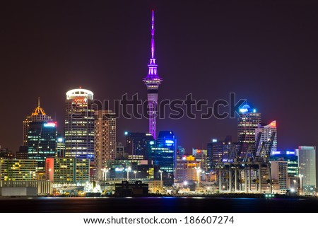 AUCKLAND, NEW ZEALAND - APRIL 10: The Sky Tower glowing royal purple to celebrate the Royal tour of New Zealand on April 10, 2014 in Auckland, New Zealand.