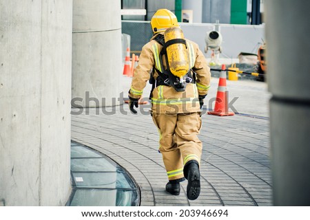 Firefighter running with all their gear