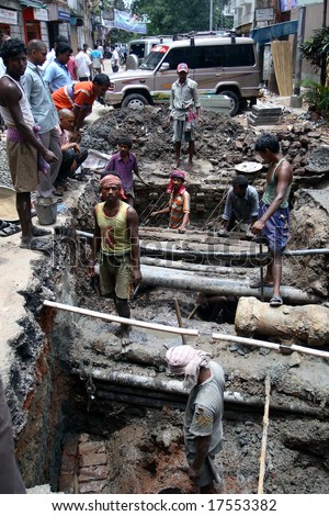 CALCUTTA, INDIA - JUNE 14: a group of Indian workers during working hours on the street June 14, 2008 in Calcutta, India