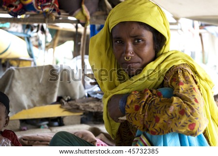 AGRA, INDIA - JUNE 19: Portrait of old tribal woman in a village in india, from Agra June 19, 2008 in Agra, India. Local women wear colorful saree (sari) as traditional clothing.
