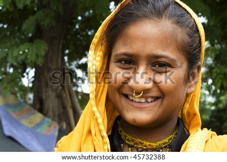 AGRA, INDIA - JUNE 19: Portrait of happy tribal woman in a village in india, from Agra June 19, 2008 in Agra, India. Local women wear colorful saree (sari) as traditional clothing.