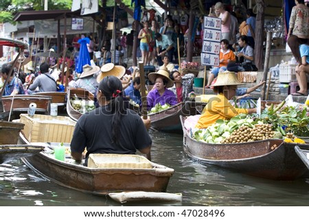 AMPAWA, THAILAND - JULY 28: Food vendors work on boats at the floating market on July 28, 2009 in Ampawa, Thailand. Ampawa is a very popular tourist attraction in Thailand.