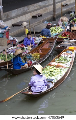 AMPAWA, THAILAND - JULY 28: Food vendors work on boats at the floating market on July 28, 2009 in Ampawa, Thailand. Ampawa is a very popular tourist attraction in Thailand.