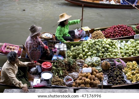 AMPAWA, THAILAND - JULY 28: Food vendor works on boats at the floating market on July 28, 2009 in Ampawa, Thailand. Ampawa is a very popular tourist attraction in Thailand.