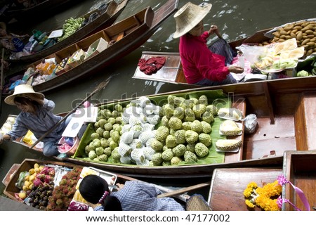 AMPAWA, THAILAND - JULY 28: Food vendor works on boats at the floating market on July 28, 2009 in Ampawa, Thailand. Ampawa is a very popular tourist attraction in Thailand.