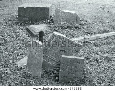 piled up broken grave stones in cemetary no longer used