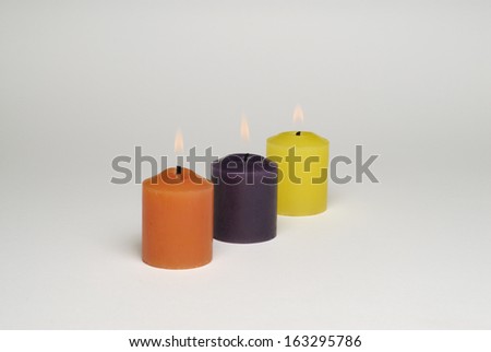three candles on a white background