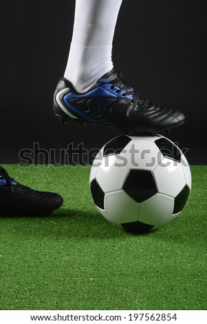 Football player with a foot over the ball