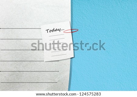 note paper and red paper-clip on blank paper