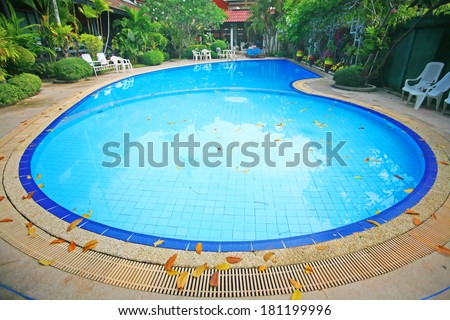 Outdoor in ground residential swimming pool in backyard with hot tub