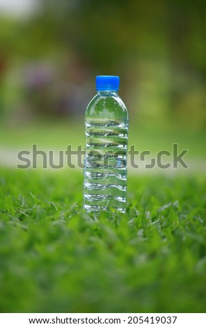 water bottle on green grass