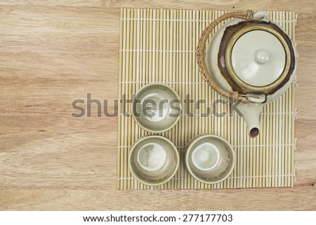 wooden dish with Asia tea pot and tea cup on wooden table