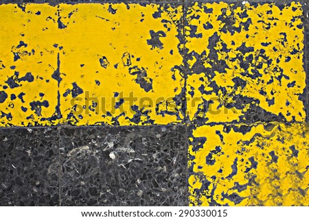 terrazzo floor with grunge yellow paint.