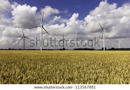 Wind farm in a wheat field and a storm brewing, near Lisset, Yorkshire, UK
