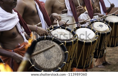Kannur, Kerala, India. Theyyam percussionists beat out the drums during a Theyyam performance at a small village in north Kerala.