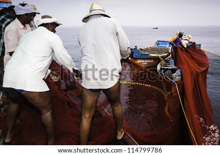 KANNUR - DECEMBER 22: unidentified fishermen pull in a catch of sardine off the Malabar Coast on December 22, 2011 near Mapilla Bay Harbour, Kannur, Kerala, India.