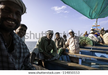 KANNUR - DECEMBER 22: unidentified fishermen enjoy a break from work whilst out at sea on board ship on December 22, 2011 along the Malabar Coast off Mapilla Bay Harbour at Kannur, Kerala, India.