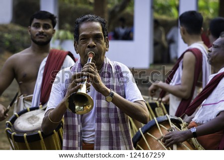 KANNUR, INDIA - DECEMBER 11: Unidentified musicians provide the essential music and percussion for an important Theyyam religious dance/drama performance on December 11, 2011 at Kannur, Kerala, India.