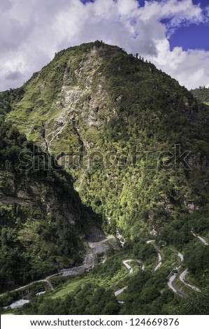 Tawang, Arunachal Pradesh, India. View of the mountains, deep valleys, and the main twisting road to Tawang in western Arunachal Pradesh, India.