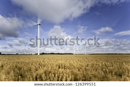 Beverley, Yorkshire, UK. View of a wind farm in the middle of a wheat field on a bright, sunny summer\'s day near the market town of Beverley, Yorkshire, UK.