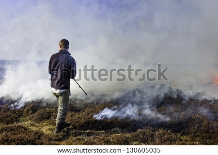 GOATHLAND, UK - MARCH 06: Unidentified moorland management employee sets fire to  heather to help invigorate fresh growth on March 06, 2013 in the North York Moors near Goathland, Yorkshire, UK.