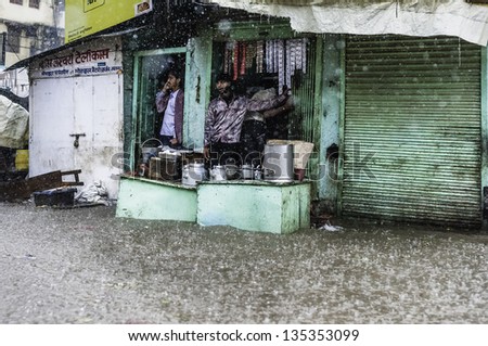 VARANASI, INDIA - AUGUST 11: monsoon rain and flash flood yet tea stall is still open for business on August 11, 2011 in Varanasi, Uttar Pradesh, India.