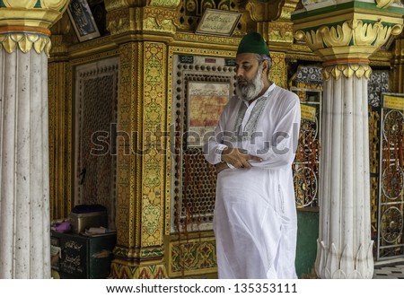 DELHI, INDIA - AUGUST 06: An unidentified man prays during an important religious festival at the ancient and beautiful mosque on August 06, 2011 at Nizamuddin, Old Delhi, India.