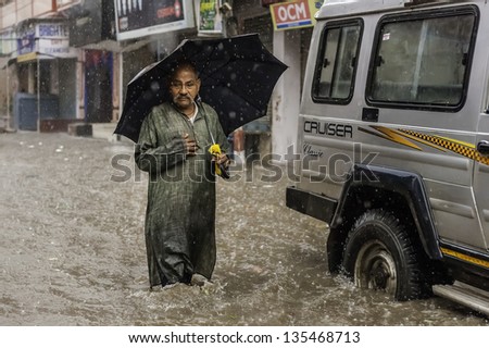 Varanasi, India - August 11: Heavy Monsoon Rain Causes A Flash Flood And This Man Finds Himself Momentarily Stranded On August 11, 2011 In Varanasi, India.