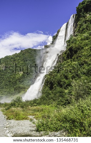 Tawang, Arunachal Pradesh, India. A high waterfall on a bright sunny morning high in the mountains near the town of Tawang in western Arunachal Pradesh, north east India.