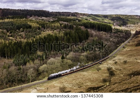 GOATHLAND, UK - APRIL 30: a vintage steam train makes the spring run between Goathland and Pickering  in the North York Moors National Park on April 30, 2013 near Levisham, Yorkshire, UK.
