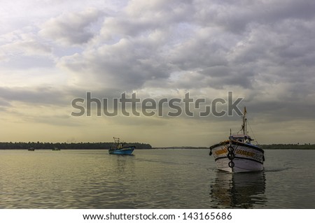 KANNUR, INDIA - DECEMBER 30, 2011: a traditional fishing trawler returns from a deep sea fishing trip in the Arabian Sea on December 30, 2011 to Valapattanam harbour, Kannur, Kerala, India.