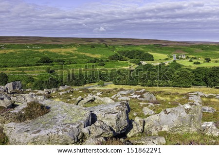 Goathland, Yorkshire, UK.  The North York Moors in summer showing rocks from the Jurassic, heather, and the undulating landscape near Goathland, Yorkshire, UK.
