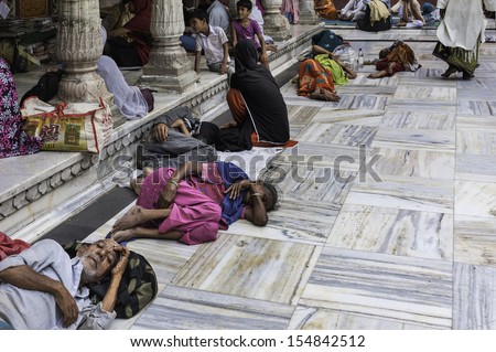 DELHI, INDIA - AUGUST 06: The sick, infirm, elderly, and the devout at the ancient Sufi Mosque in Nizamuddin on August 06, 2011 in Delhi, India.